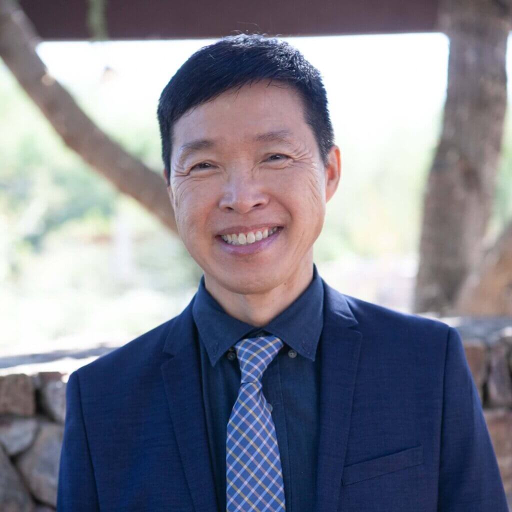 Warren Chue, a male eye doctor wearing a blue suit